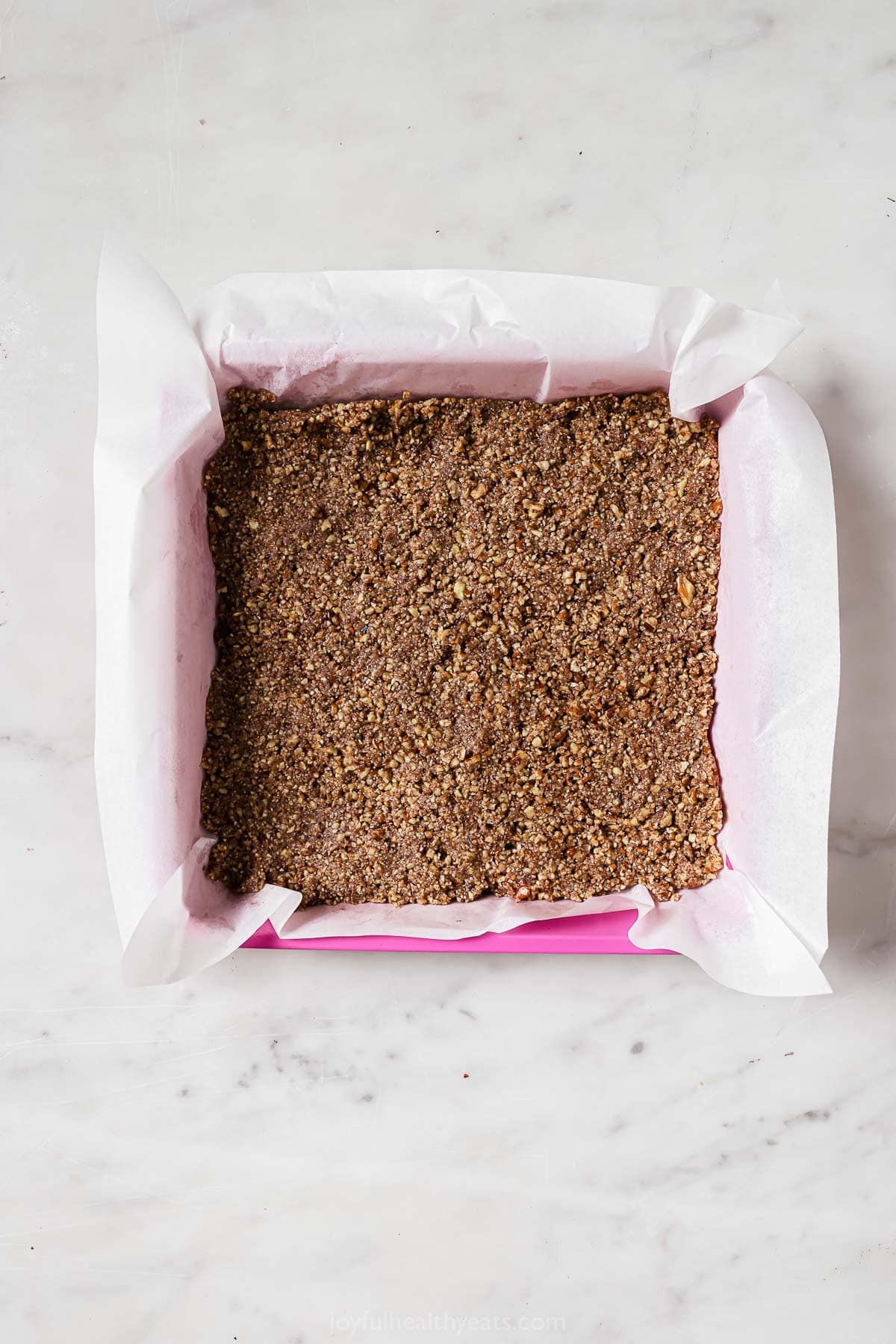 Pressing the crust into the baking dish.