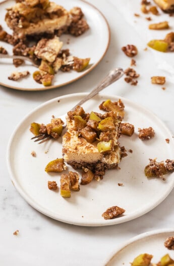 One slice of apple cheesecake bars on a plate.