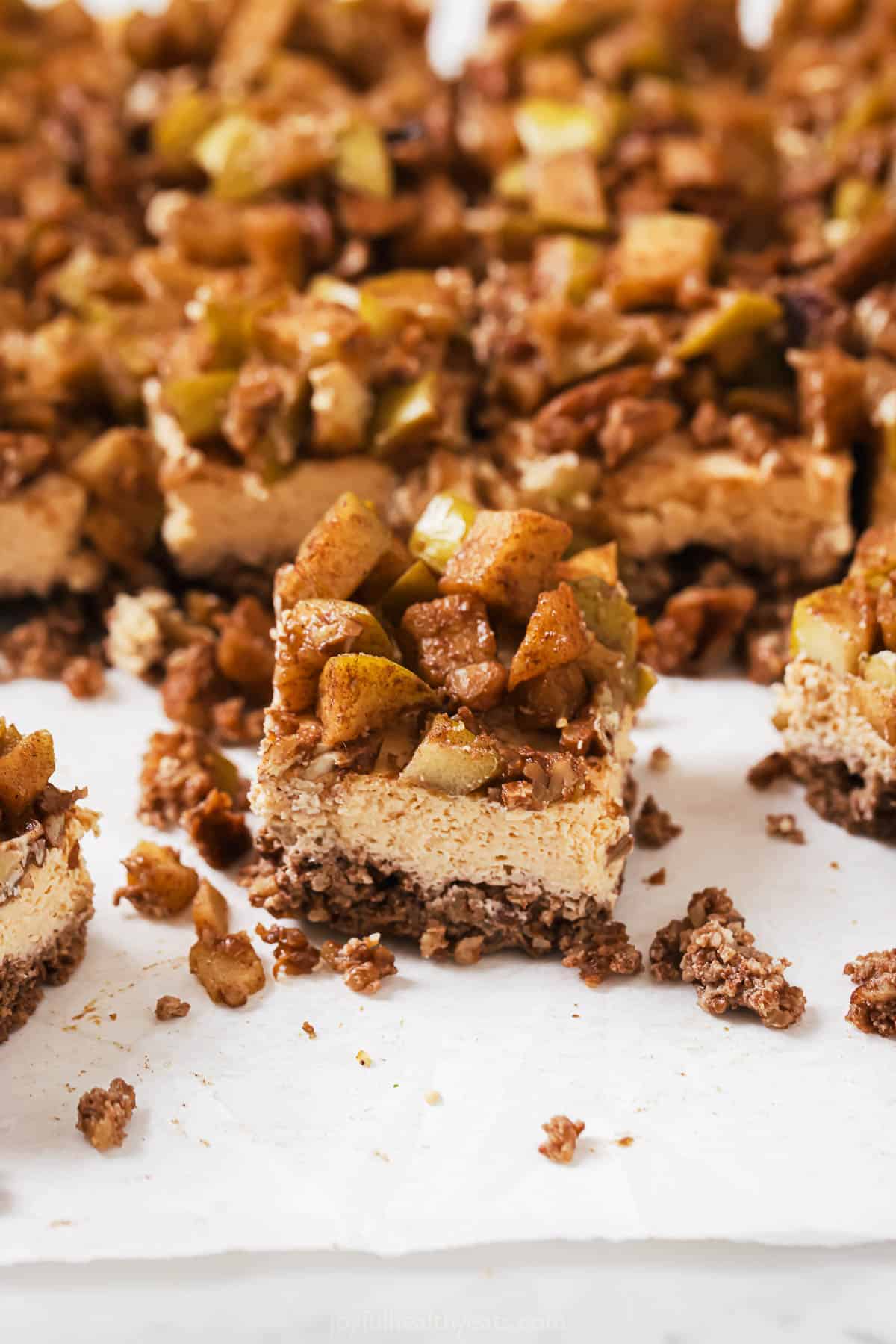 Close-up of a slice of an apple cheesecake bar.