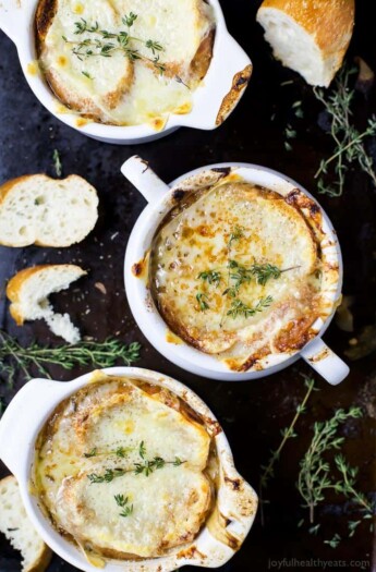 Top view of three bowls of bubbly Classic French Onion Soup