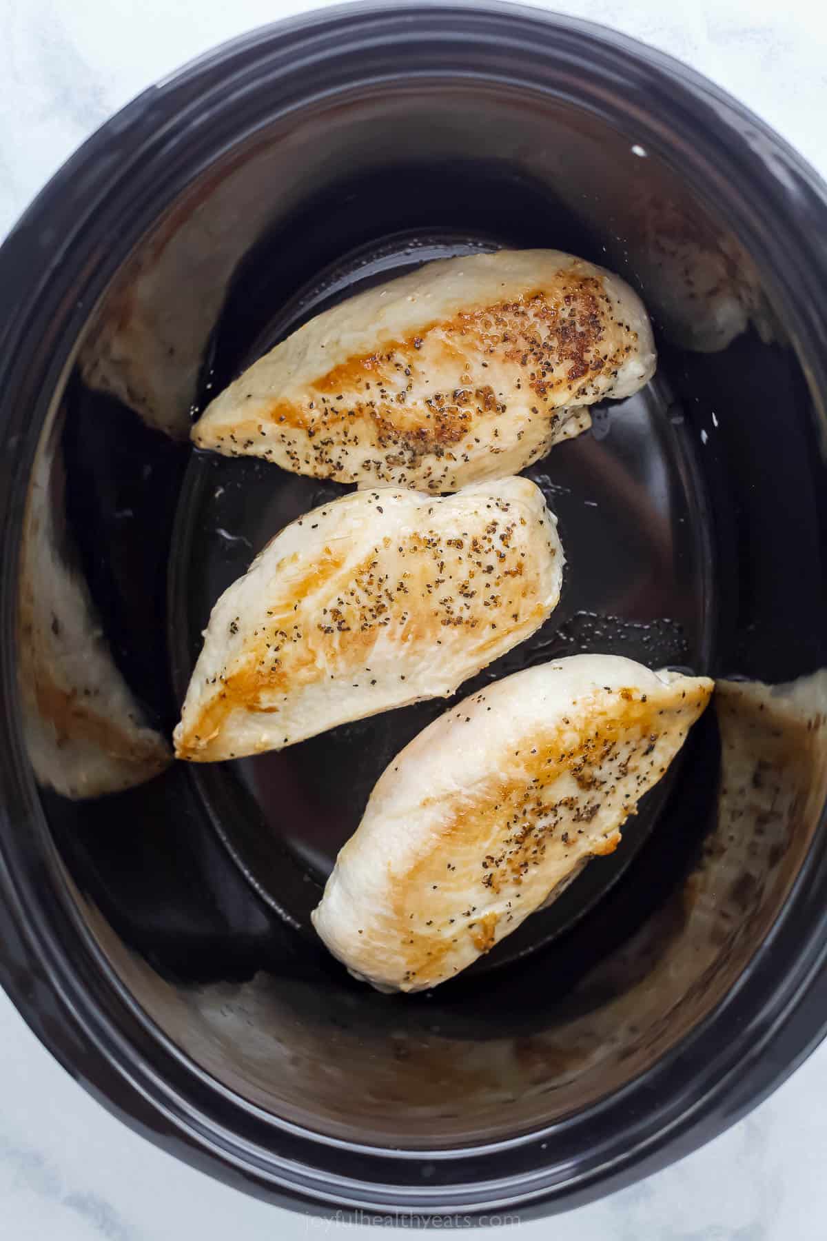 three chicken breasts in a crcokpot