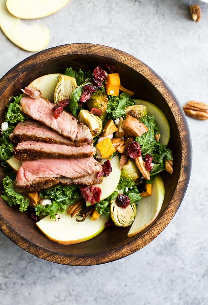 Top view of a wooden bowl of Harvest Steak Salad with autumn vegetables