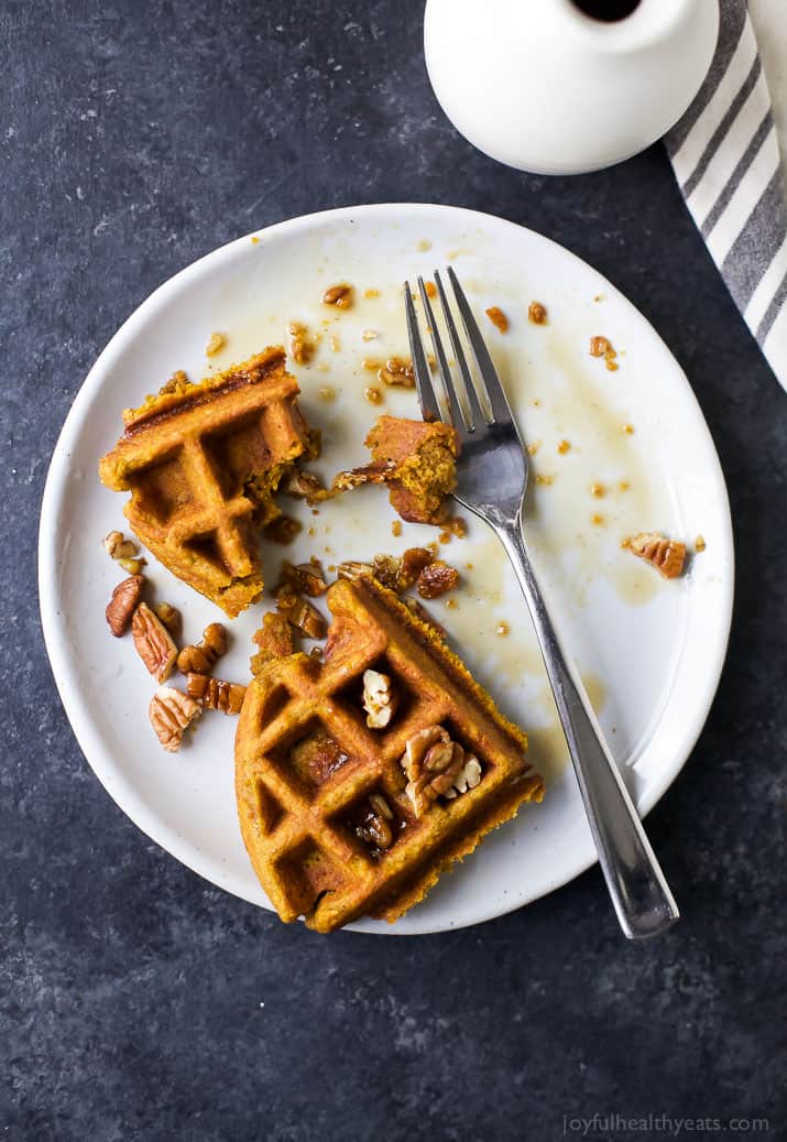 Crispy Moist Gluten Free Pumpkin Waffles made with oat flour, filled with pumpkin puree, pumpkin spice flavor then topped with a Vanilla Pecan Maple Syrup - the perfect fall breakfast!