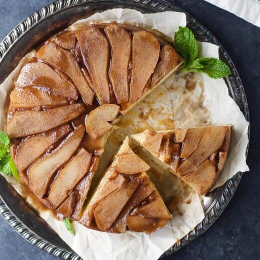 spiced pear upside down cake on a serving platter
