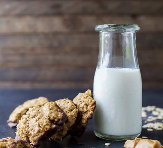 Soft & Chewy Healthy Oatmeal Peanut Butter Cookies dunked in Dark Chocolate - the perfect cookie recipe this holiday season. It's sure to be Santa's favorite!