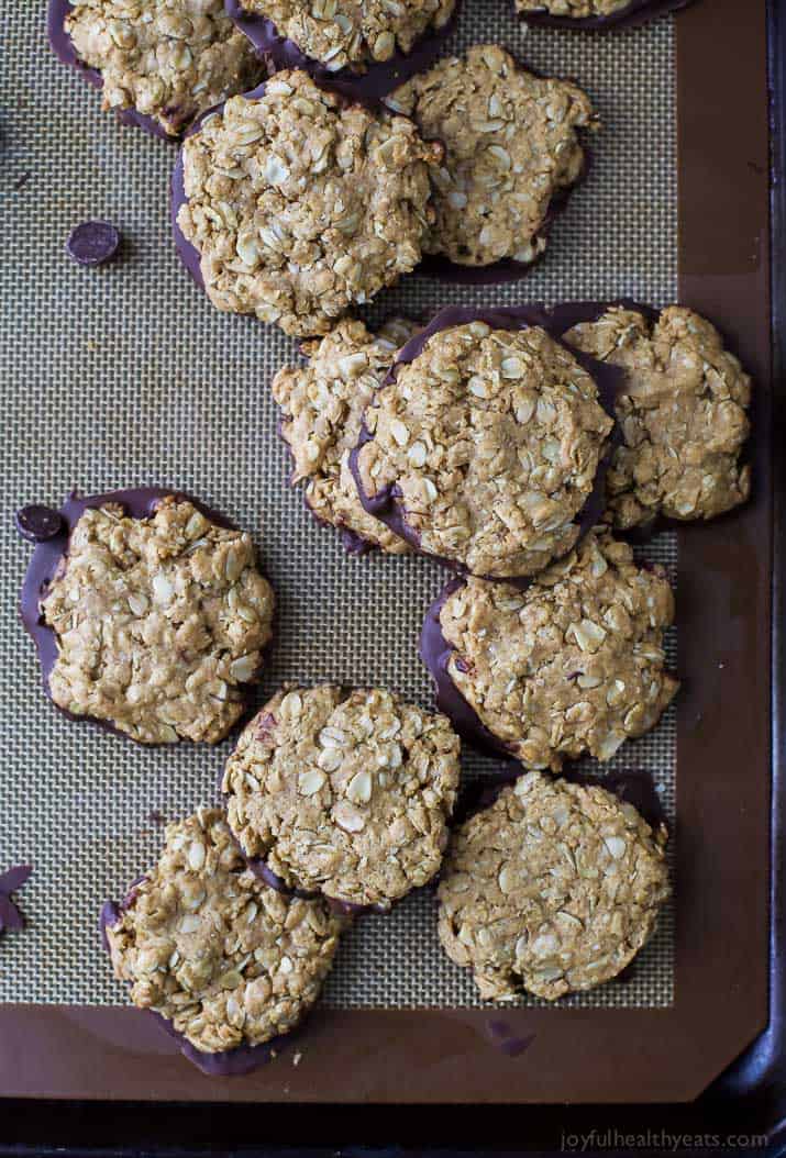 Top view of chocolate-dipped Oatmeal Peanut Butter Cookies on a baking mat