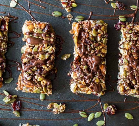 Easy Gluten Free Cranberry Almond Homemade Granola Bars - loaded with nuts, cranberries and a chocolate drizzle for good measure. These Granola Bars are perfect snack to have on hand at all times!