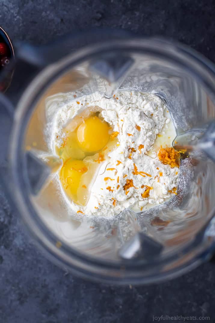 Top view of ingredients for Cranberry Orange Dutch Baby in a mixing bowl