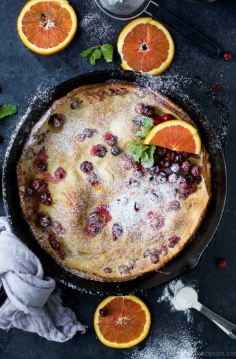 Easy Cranberry Orange Dutch Baby baked till crispy on the outside and fluffy on the inside. A stunning festive breakfast recipe that's perfect for the holidays!