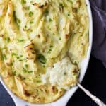 sour cream and chive mashed potatoes in a baking dish