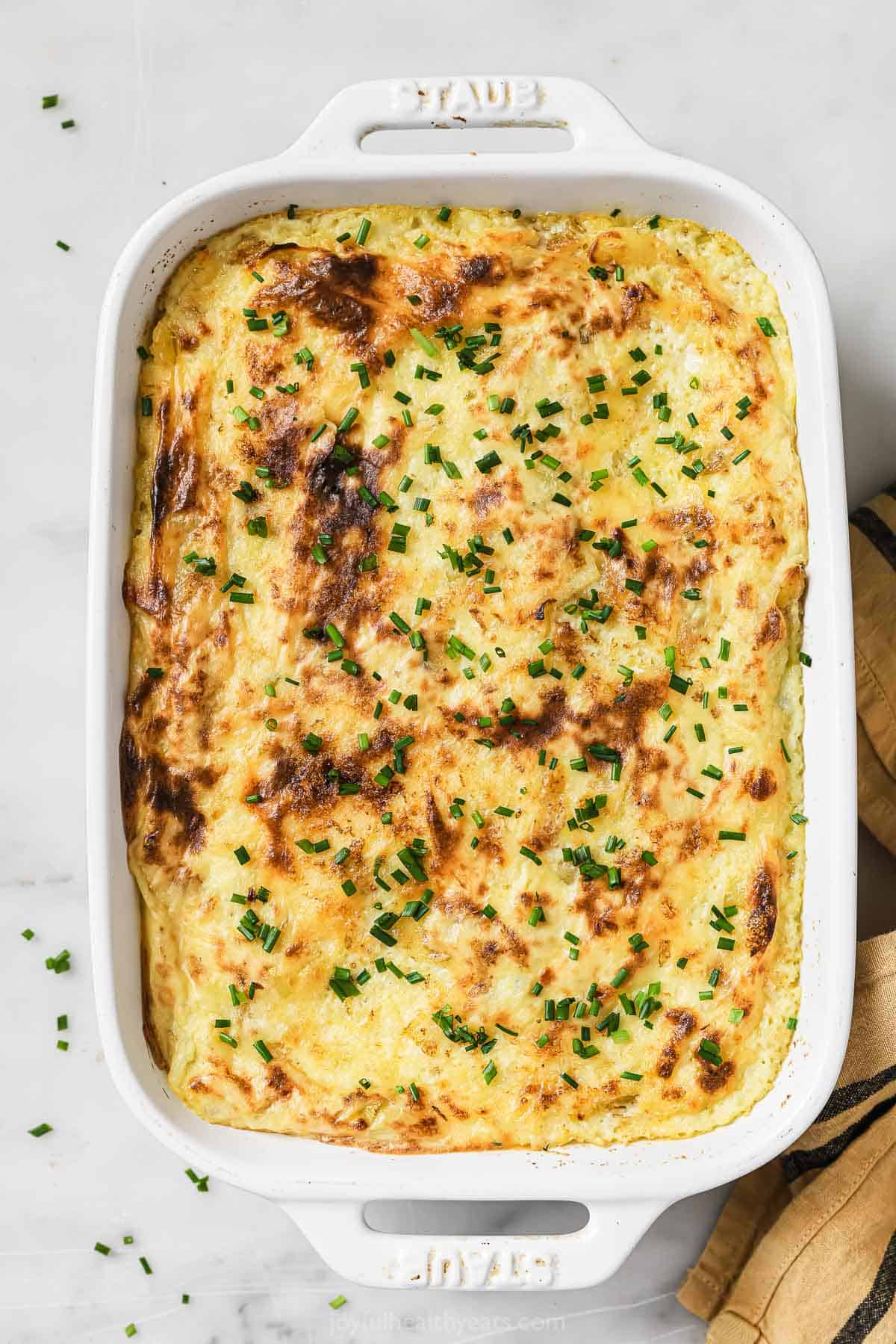 Sour cream and chive mashed potatoes in a baking dish.