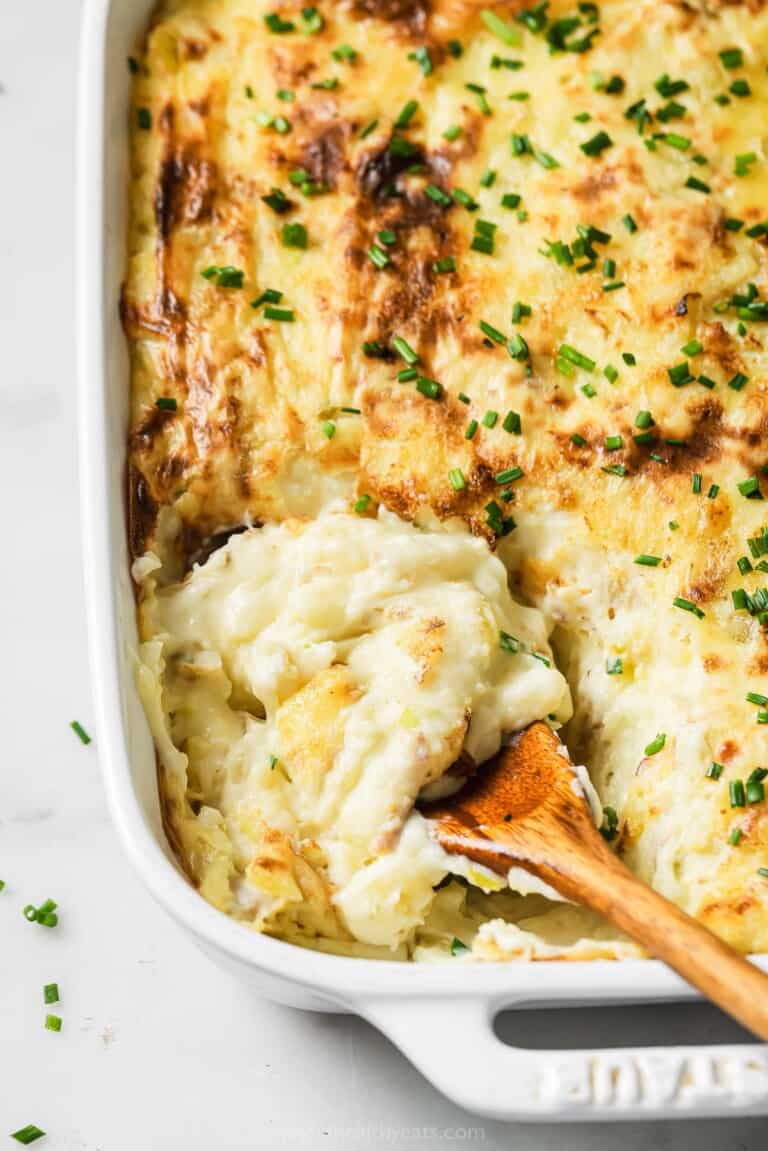 Grabbing some mashed potatoes with a wooden spoon.