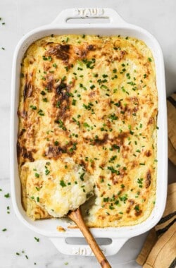 Mashed potatoes with chives in a baking dish.