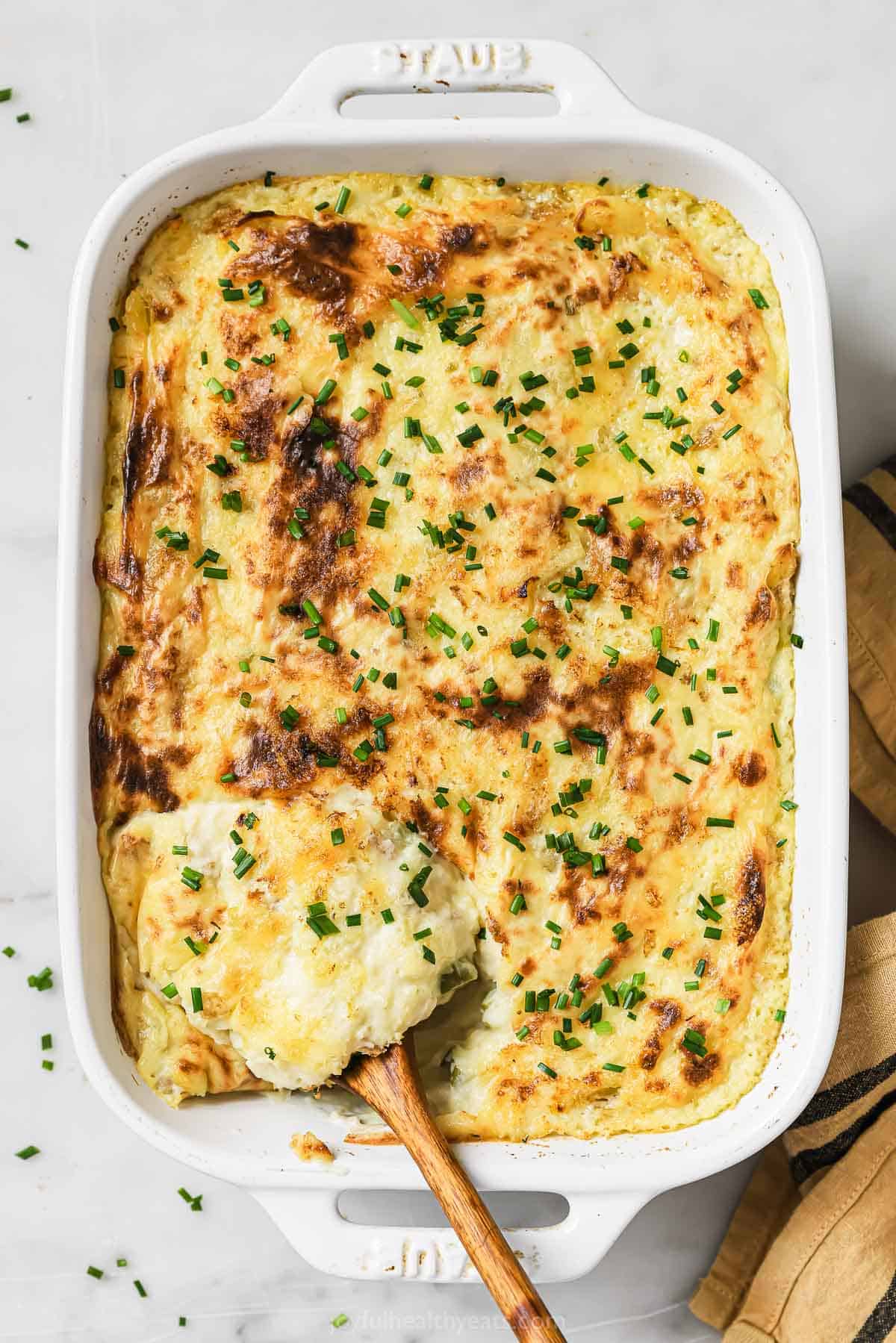 Mashed potatoes with chives in a baking dish. 