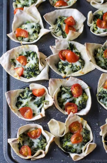 Easy Baked Wonton Bites filled with homemade Spinach Artichoke Dip - a delicious healthy appetizer perfect for entertaining a large crowd. 