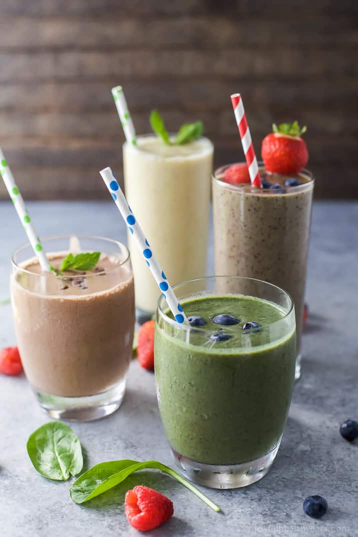 4 glasses of smoothies with straws