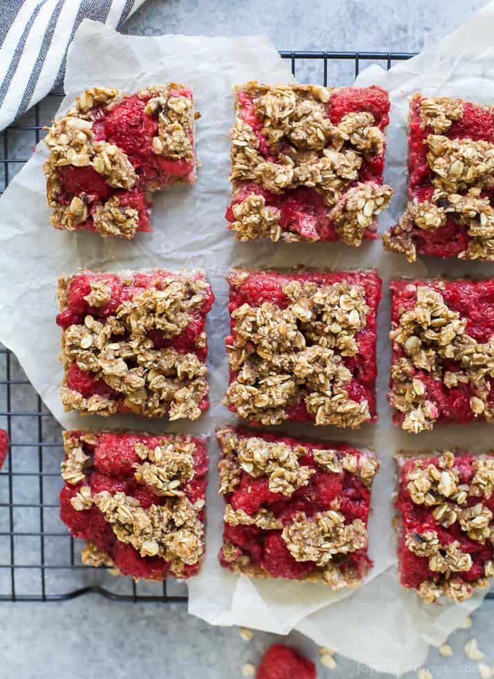 Nine Fresh Almond Oat Raspberry Bars Sitting on a Wire Cooling Rack