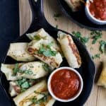 Skinny Baked Mozzarella Sticks wrapped in wonton wrappers, filled with gooey cheese, baked until golden brown and served with marinara sauce. These mozzarella sticks are the perfect party appetizer, sure to please a crowd!