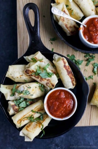 Skinny Baked Mozzarella Sticks wrapped in wonton wrappers, filled with gooey cheese, baked until golden brown and served with marinara sauce. These mozzarella sticks are the perfect party appetizer, sure to please a crowd!