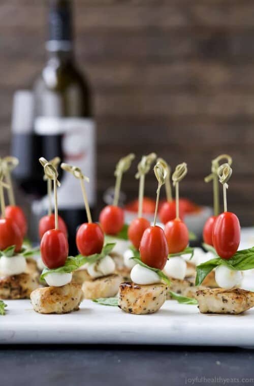 Easy Caprese Chicken Skewers drizzled with a homemade Balsamic Glaze absolutely irresistible and make the ULTIMATE party appetizer! Just watch these gluten free caprese bites disappear from the appetizer table! #ad