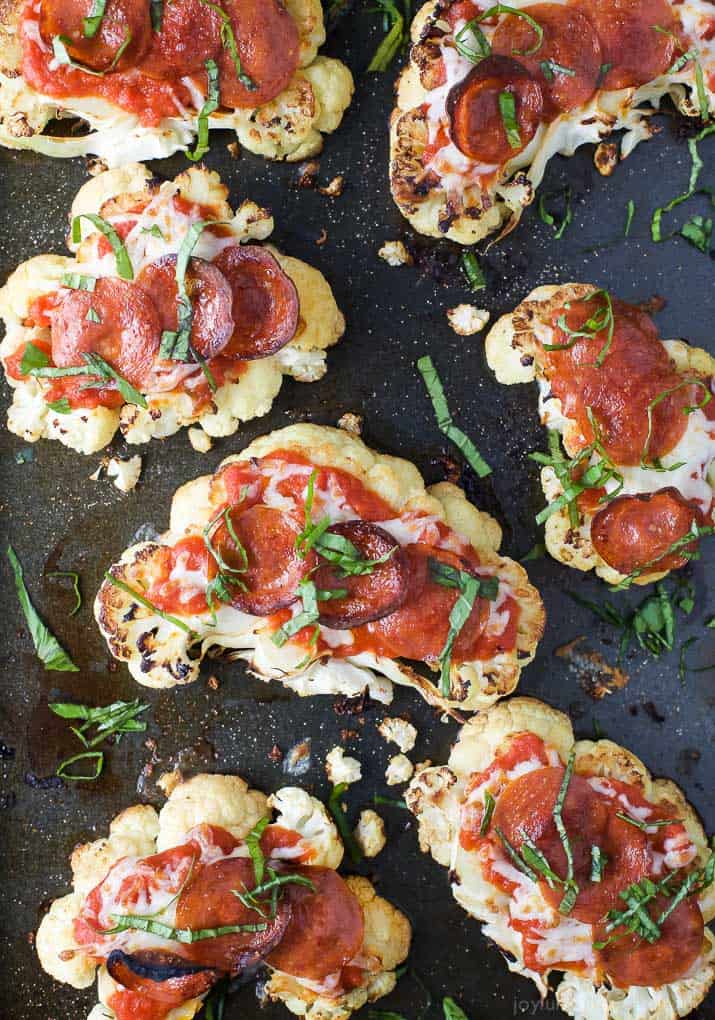 Top view of Cauliflower Steak Pepperoni Pizzas on a baking sheet