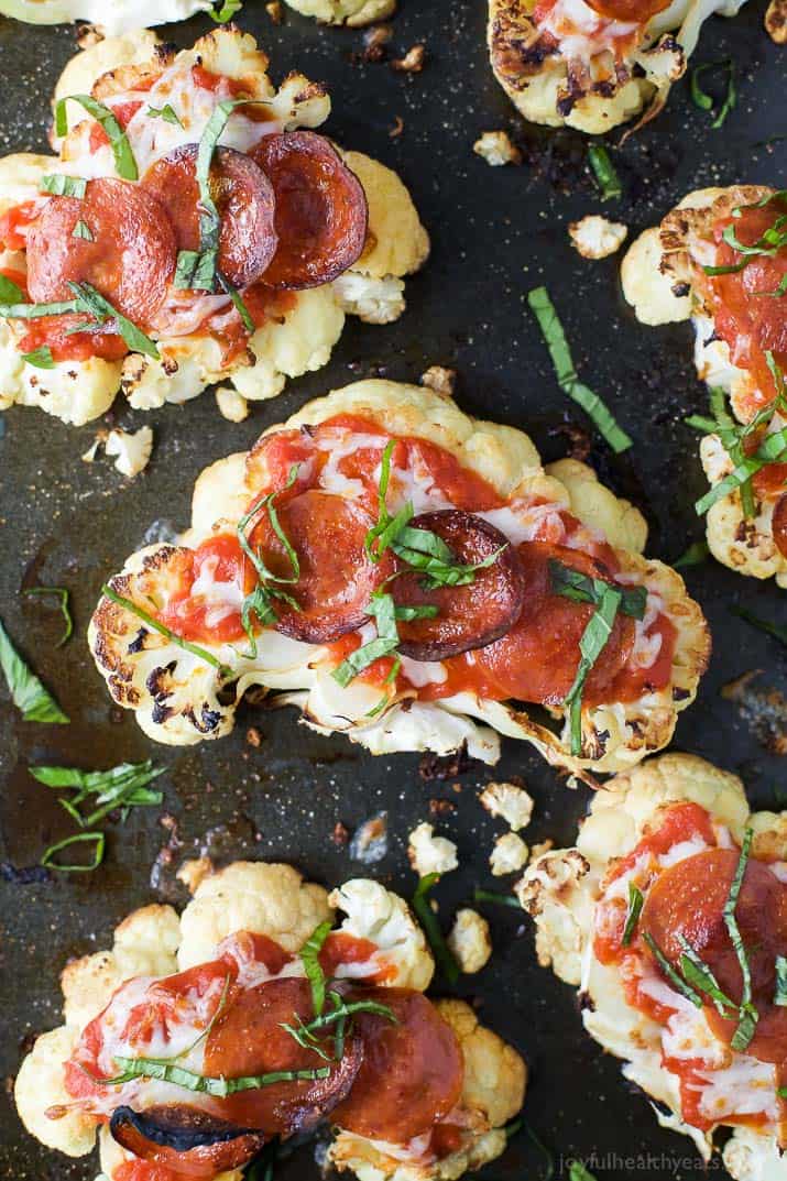 Top view of Cauliflower Steak Pepperoni Pizzas on a baking sheet