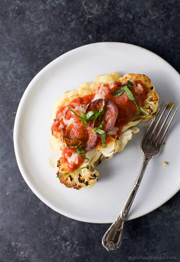 Top view of a Cauliflower Steak Pepperoni Pizza on a plate