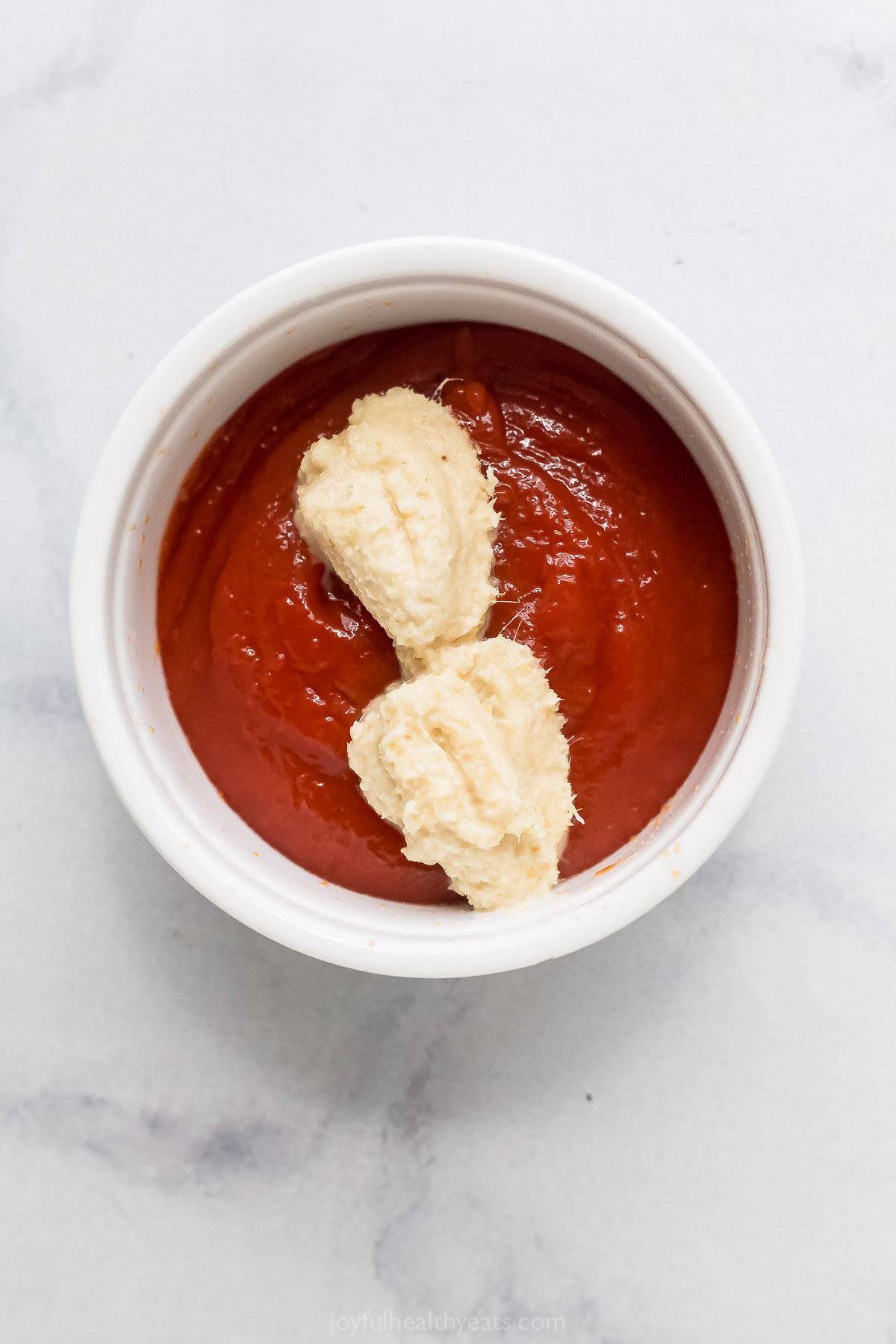 Adding the sauce ingredients to a bowl. 