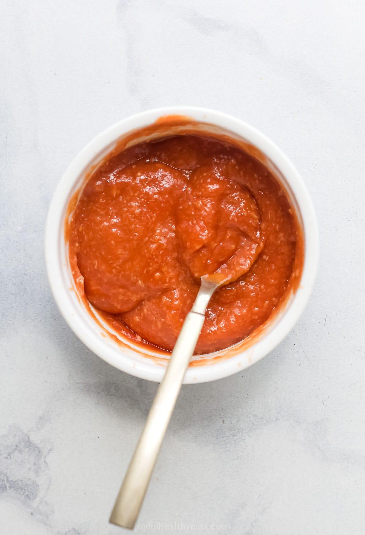 Whisking the sauce in a bowl. 