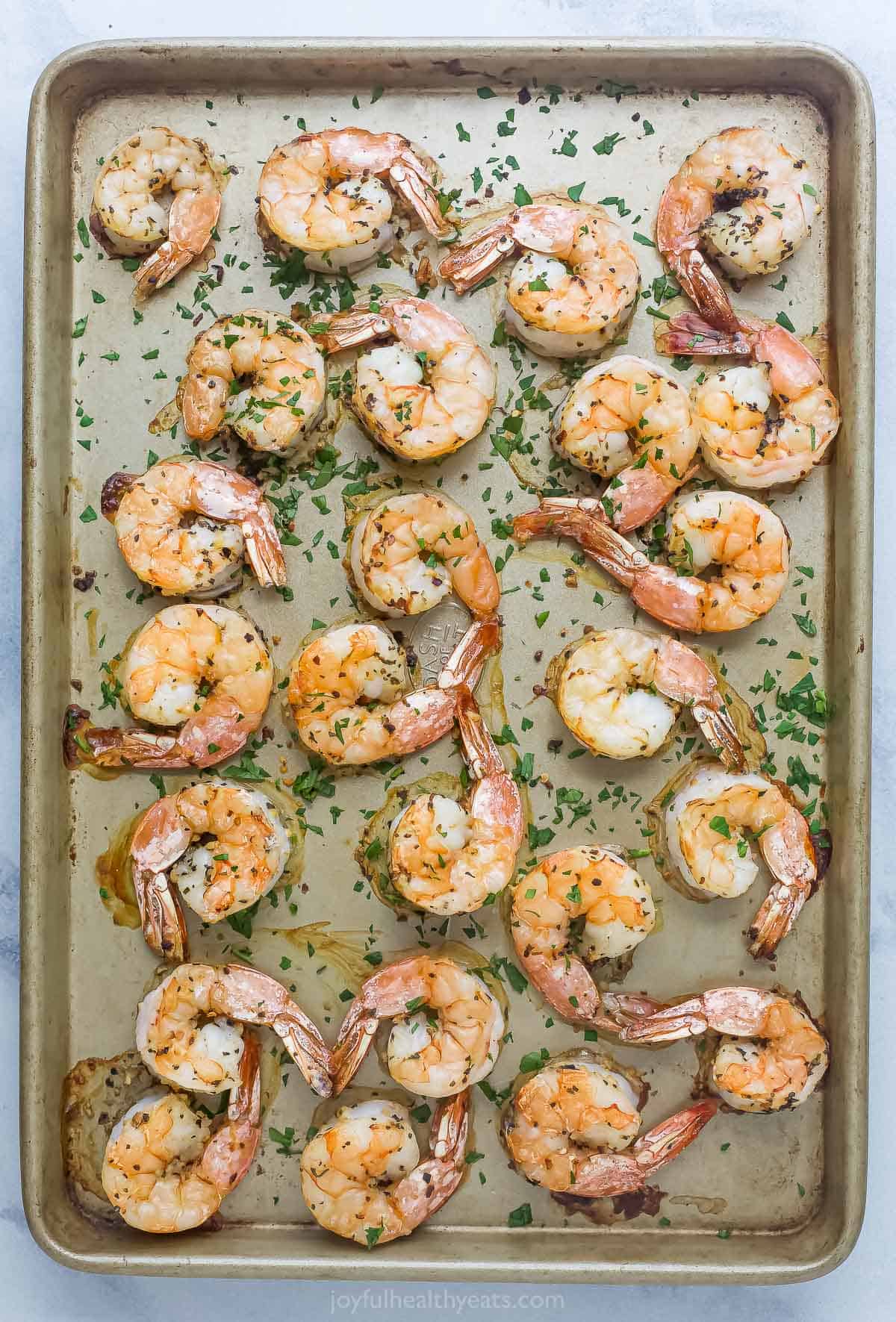 Spread shrimps on baking sheet. 