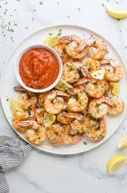 Overhead photo of baked shrimp with cocktail sauce.