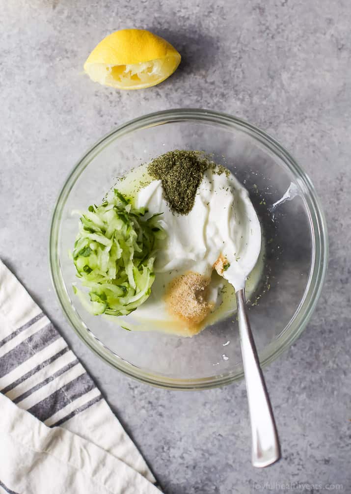 Top view of ingredients for Tzatziki Sauce in a mixing bowl