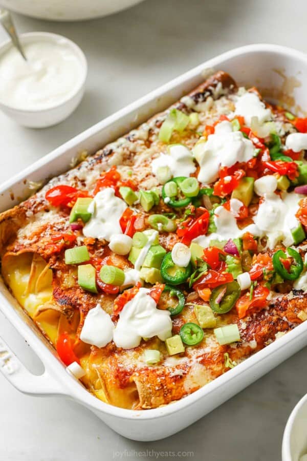 Breakfast enchiladas in the baking dish with enchiladas.