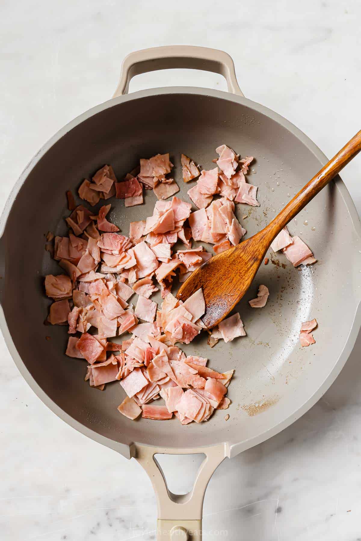 Browning the ham in the skillet. 