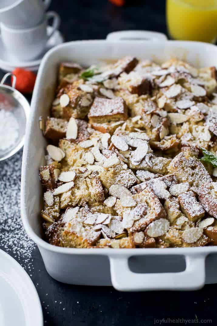 A close-up shot of an overnight French toast casserole inside of a white casserole dish