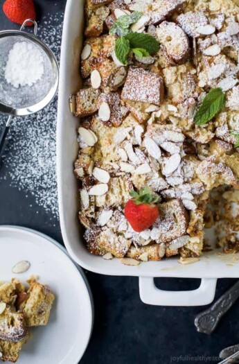 A Christmas casserole topped with powdered sugar and fresh strawberries