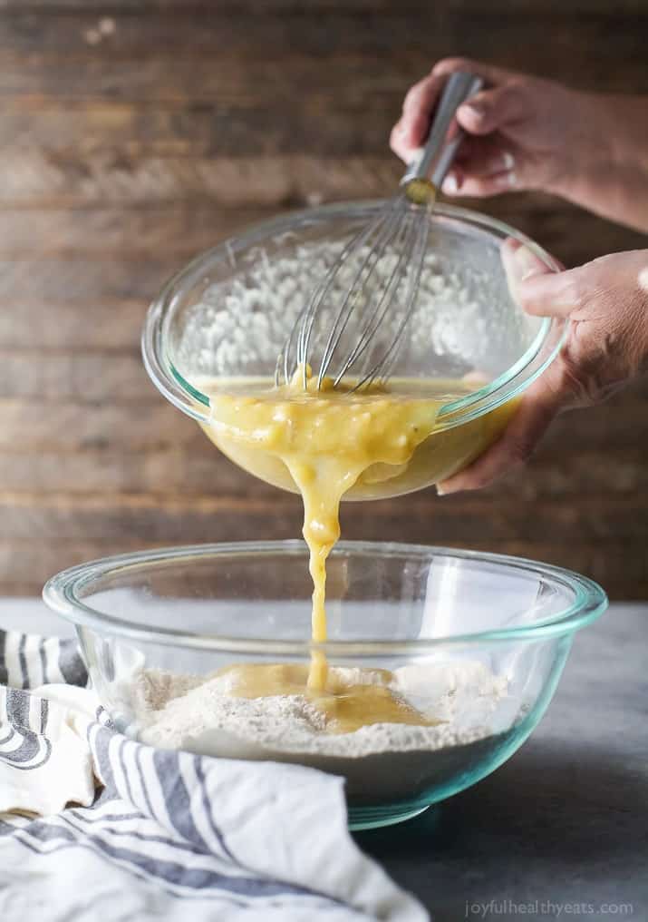 Pouring the wet ingredients into the dry ingredients.