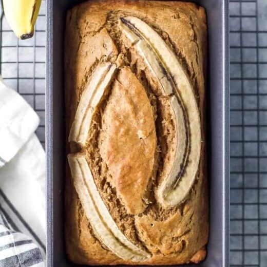 Banana bread on baking pan cooling on rack.