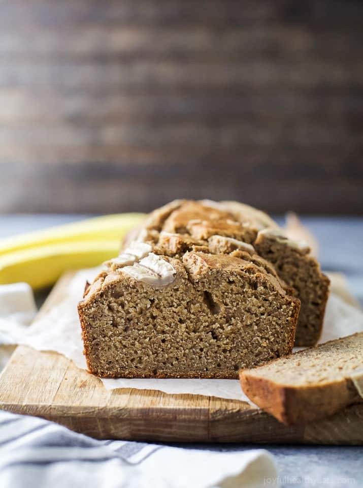 This cinnamon-banana bread recipe is sweetened with maple syrup for a healthy, on-the-go, dessert-like breakfast. Side view of a slice of fluffy banana bread.