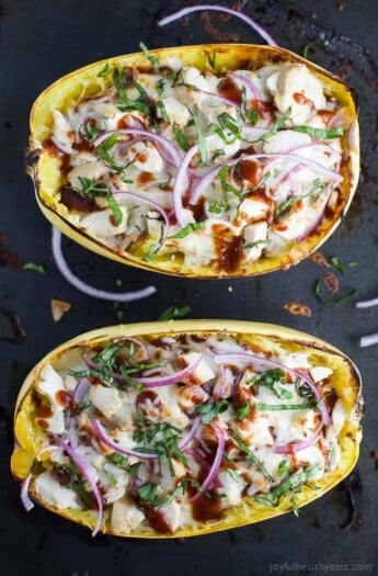 Easy Low Carb BBQ Chicken Pizza Stuffed Spaghetti Squash - filled with sweet tangy BBQ sauce, 22 grams of protein and gooey cheese. All your favorite things about BBQ Chicken Pizza for under 300 calories! #glutenfree