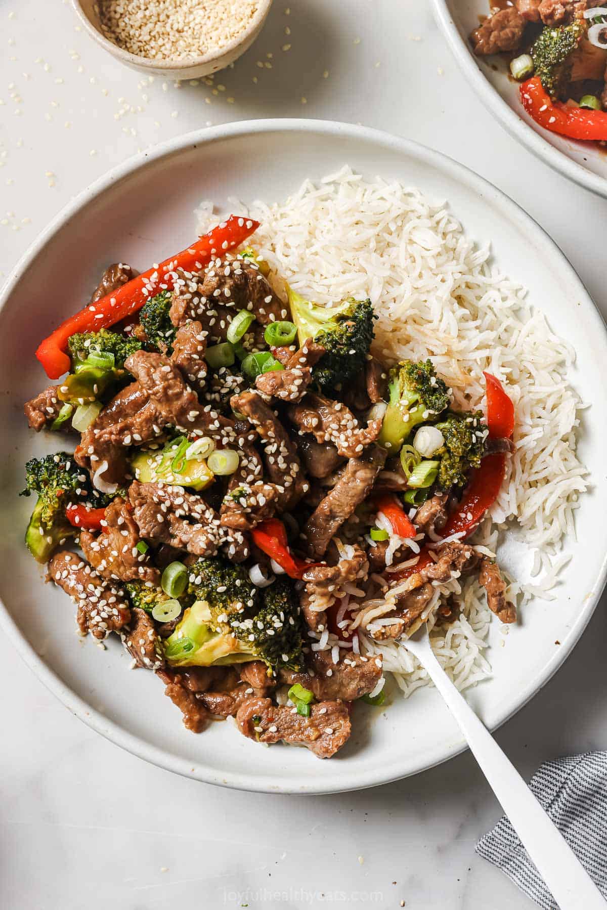 Beef and broccoli stir fry with rice noodles on the side.