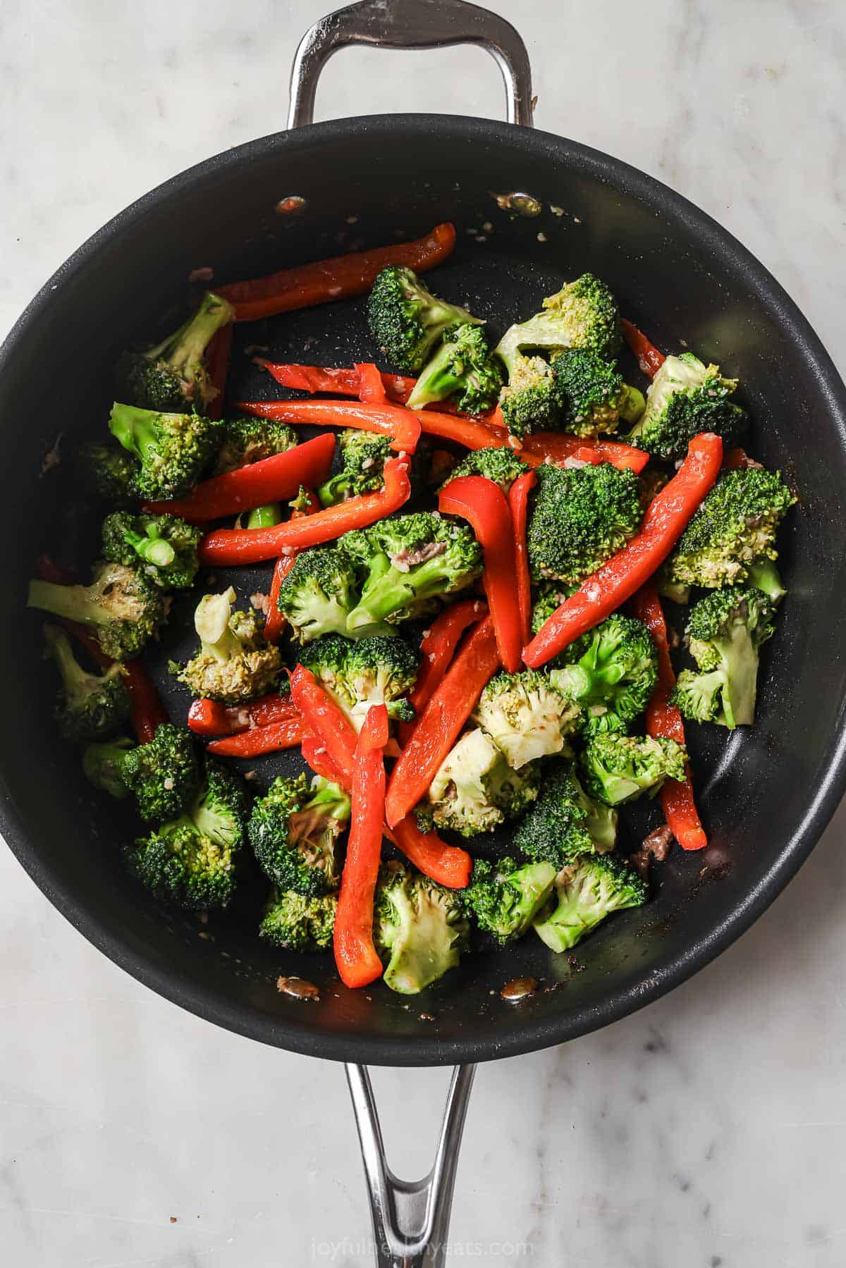 Cooking the veggies in the skillet. 