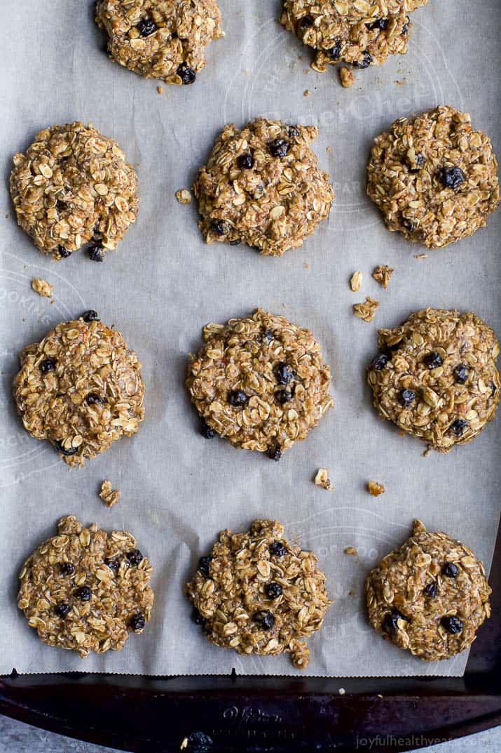 Baked blueberry oatmeal cookies on a baking sheet lined with parchment paper