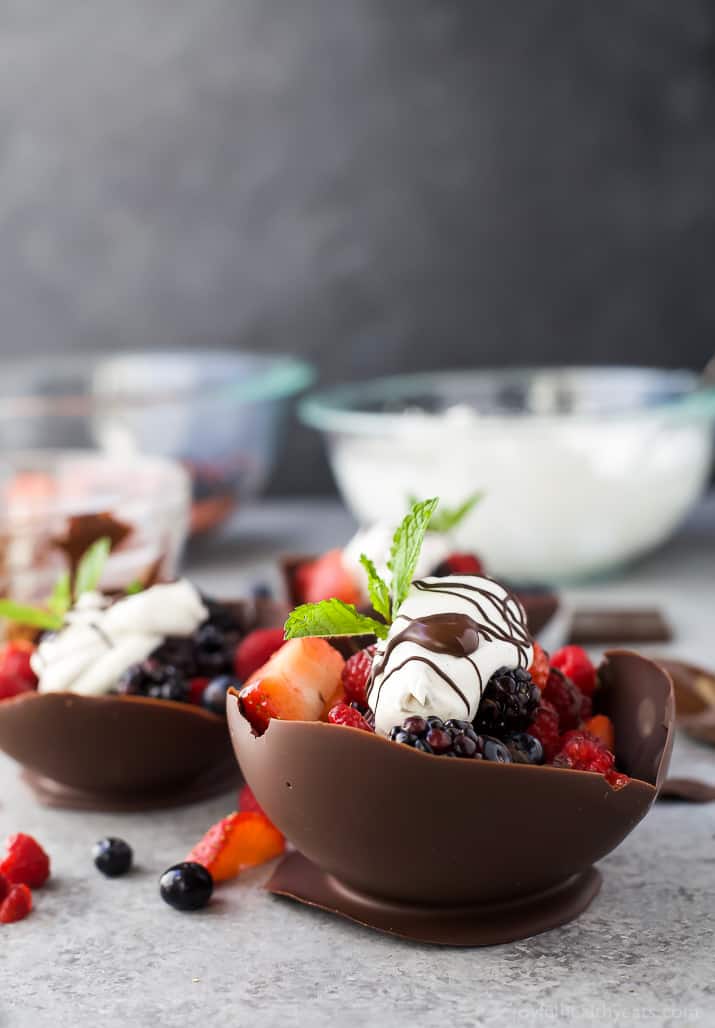 DIY Chocolate Bowls filled with fresh berries and topped with Coconut Whipped Cream