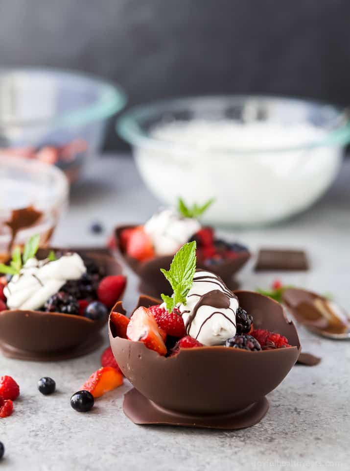 DIY Chocolate Bowls filled with fresh berries and topped with Coconut Whipped Cream