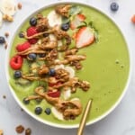 green smoothie bowl with fresh fruit and peanut butter drizzle