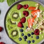 A Green Smoothie Bowl topped with fresh fruit and granola.