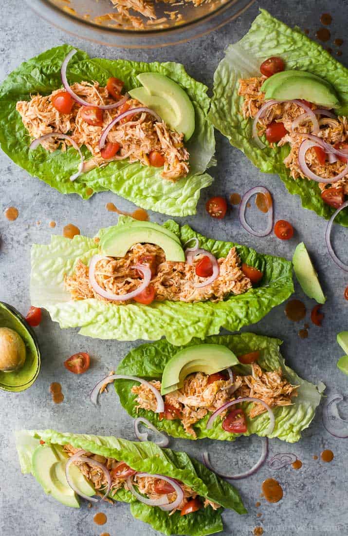 Shredded Buffalo Chicken wrapped in lettuce leaves with avocado, red onion and cherry tomatoes