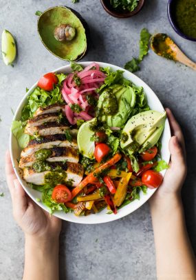 Chicken Fajita Salad with Chimichurri Dressing in a white bowl
