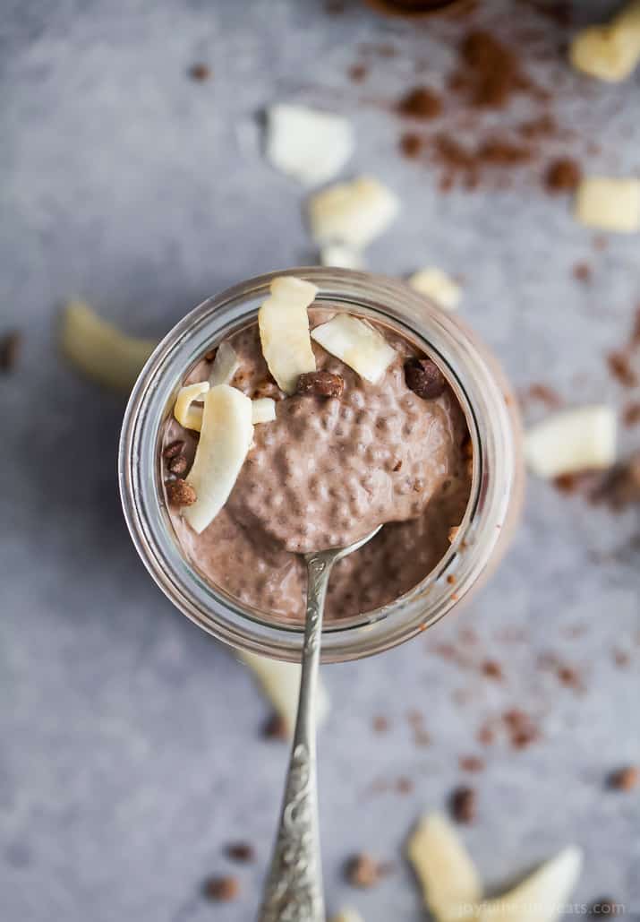 Top view of a glass of Coconut Dark Chocolate Chia Pudding topped with fresh coconut
